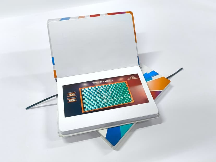 Full-color printed insert page inside the diary showcasing corporate achievements.