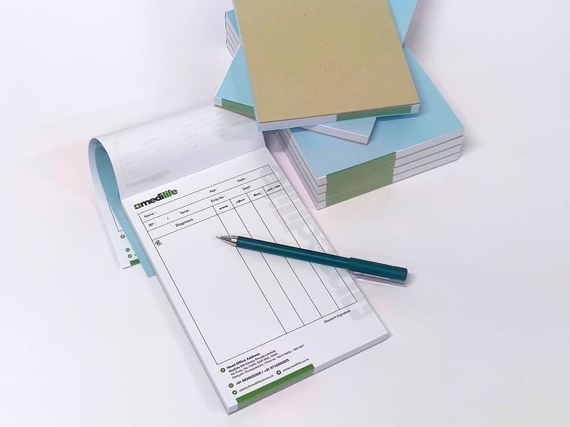 A5 prescription pad with a pen showing the table