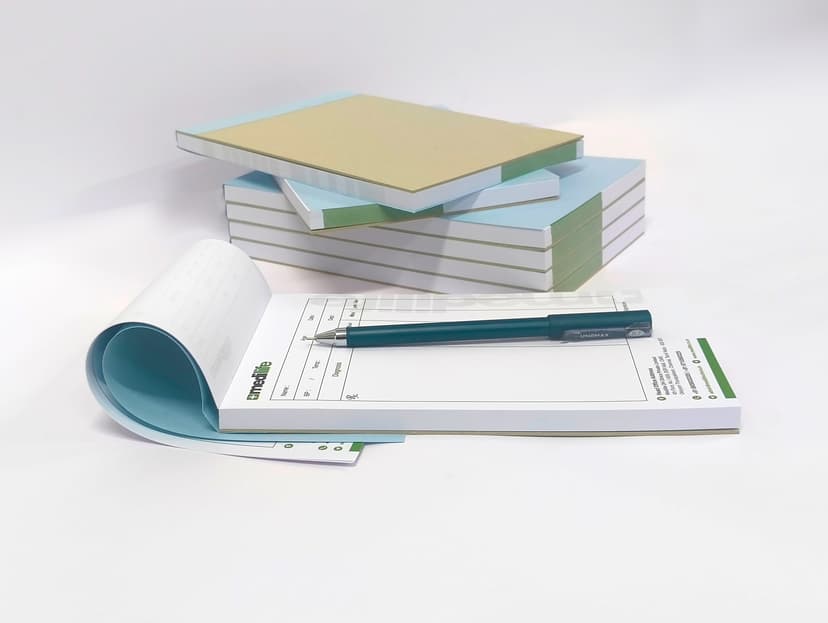 Flexible top-bound prescription pad being flipped open