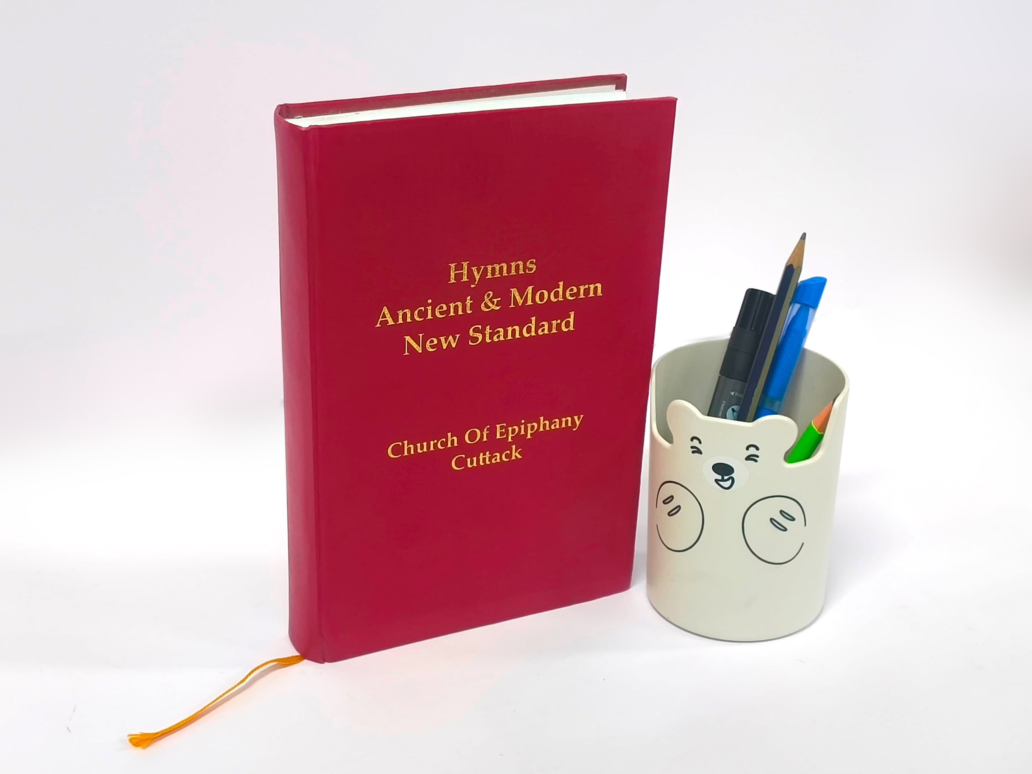 Luxury red textured hardcover book with gold foil stamped title.