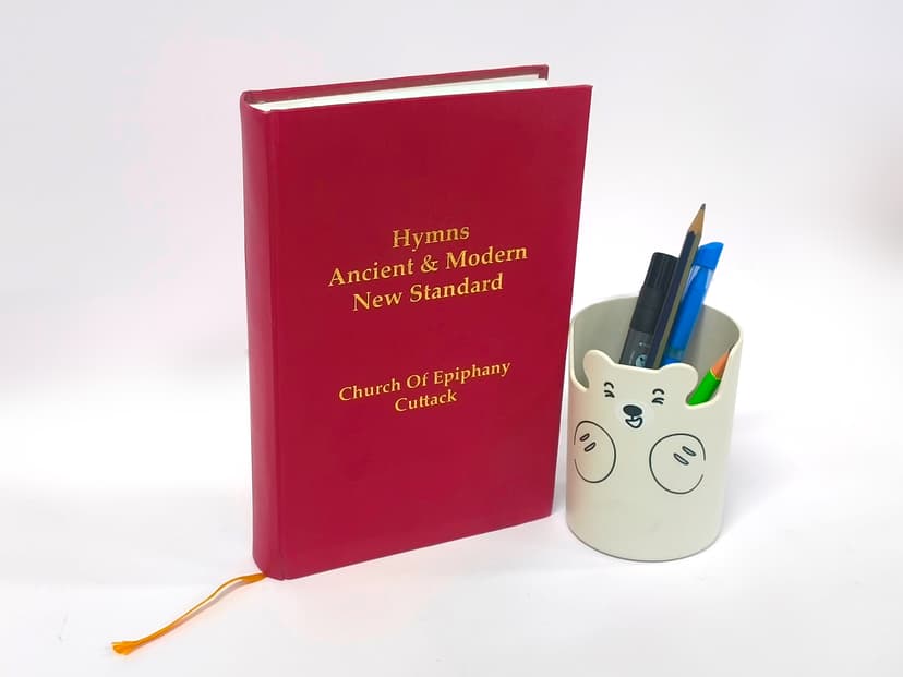 Luxury red textured hardcover book with gold foil stamped title.