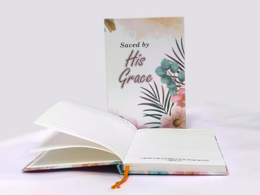 An open and closed floral hardcase journal showcasing the interior ruled pages.