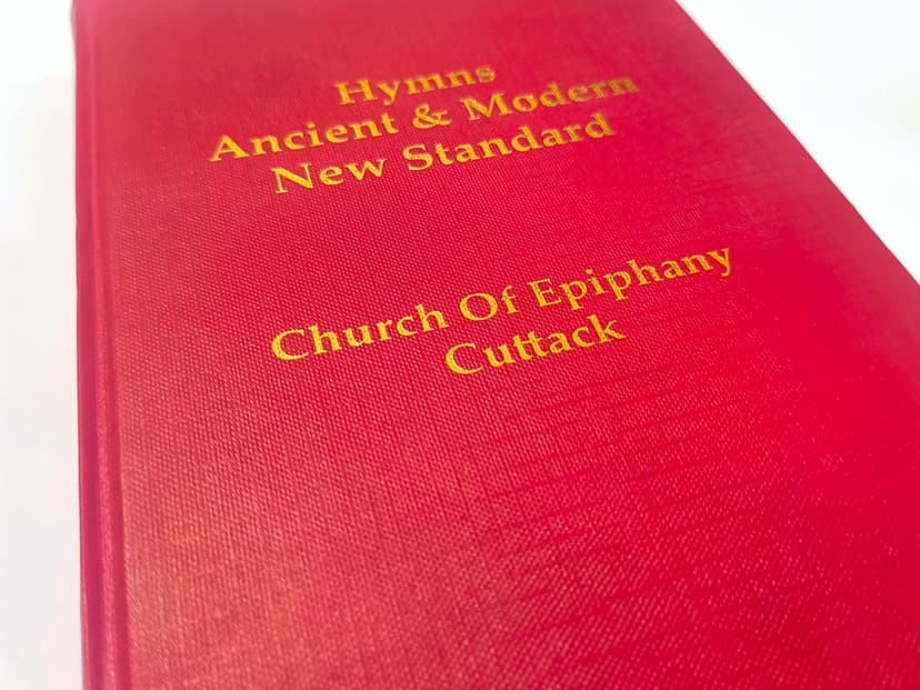 Macro shot of the gold foil texture on a red linen-style paper cover.