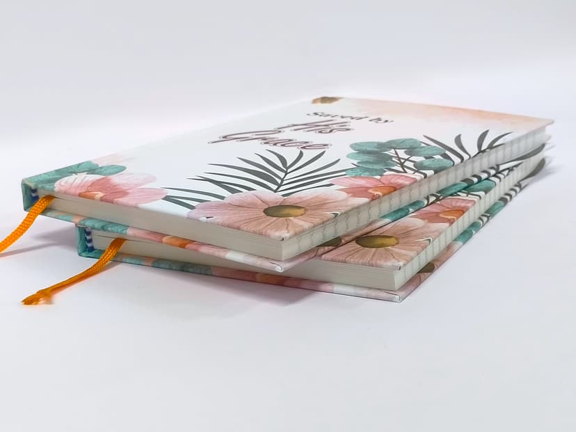 Stacked floral journals highlighting the matte cover finish and crisp edges.