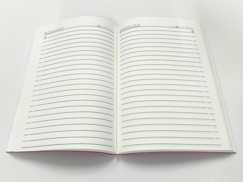 Fully opened diary showing clean, wide-ruled pages with date and day headers.