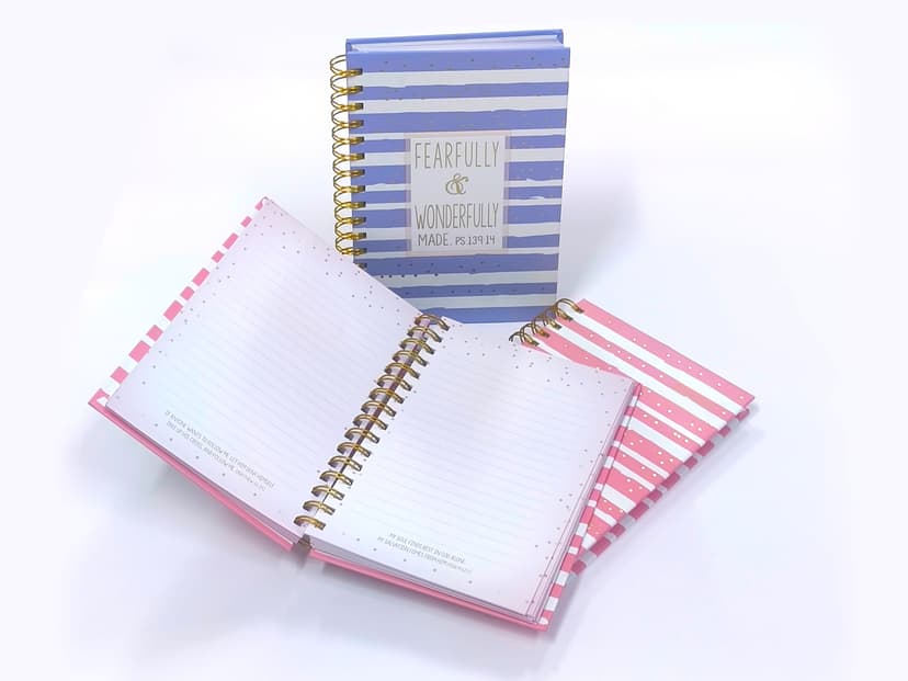 Opened journal showing multi-color ruled pages with inspirational quotes.